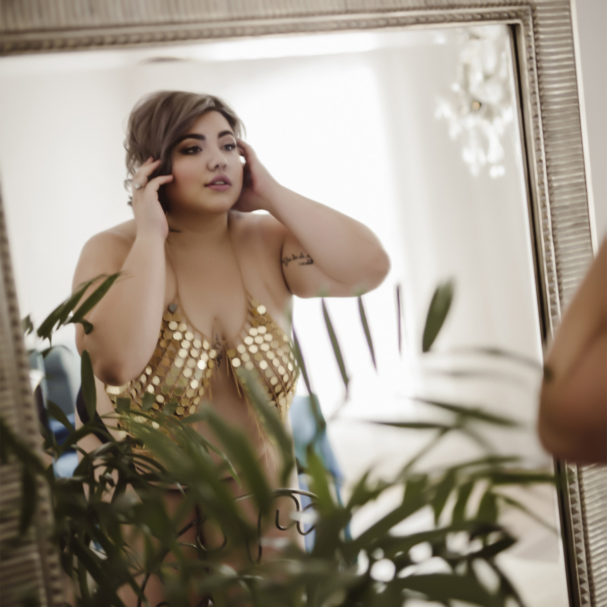Brisbane Boudoir Photography client posing in front of a mirror wearing gold sequin lingerie